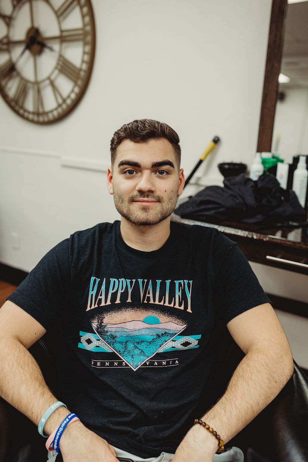 Client in a Happy Valley tee after a men's haircut at The Gentleman's Salon in State College, PA