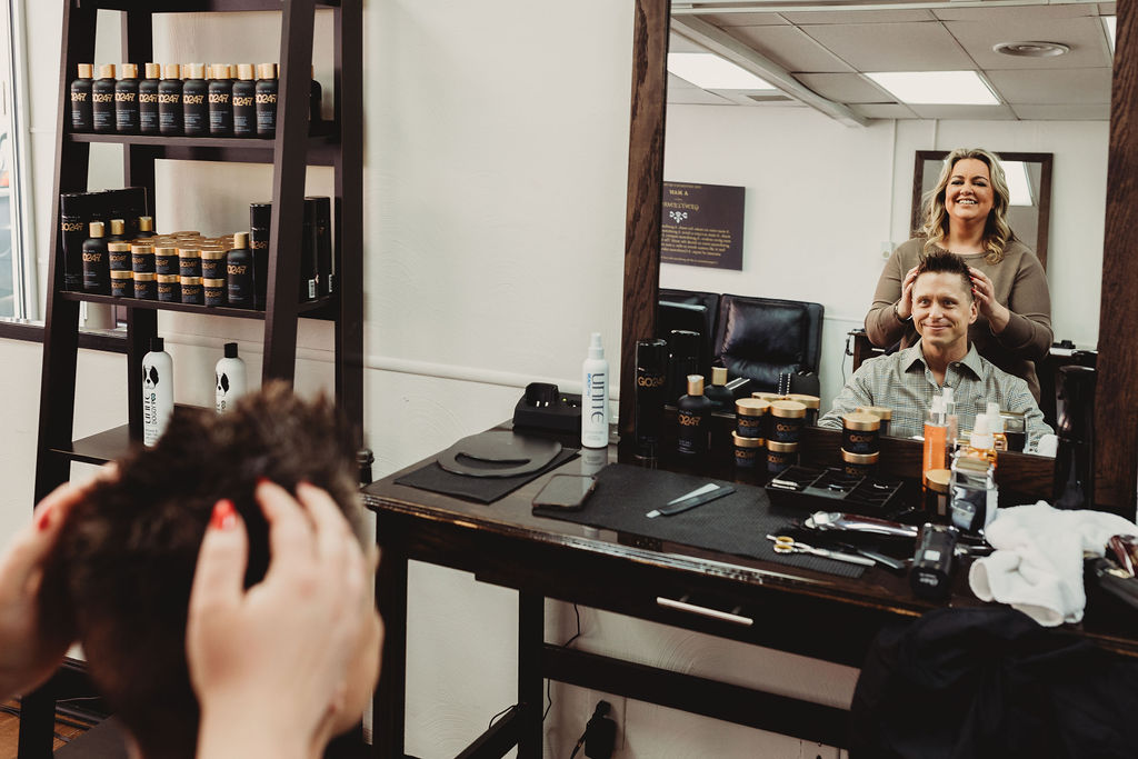 Client checking out his new hairstyle in the mirror at The Gentleman's Salon in State College, PA